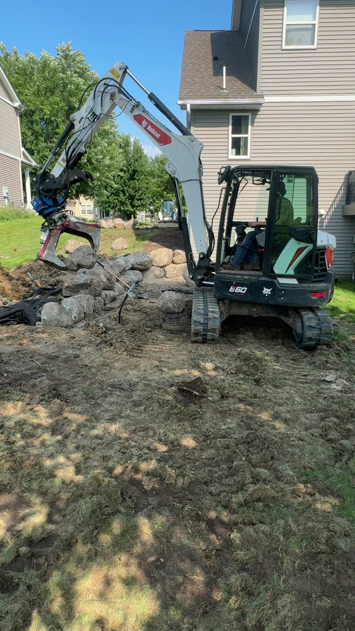 Backyard Transformation with Retaining Wall and Outdoor Kitchen in Lakeville